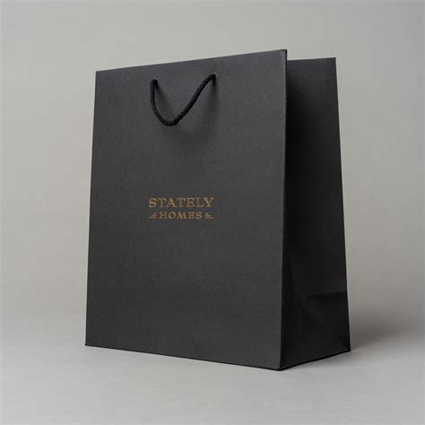 A Black Paper Bag With Gold Lettering On The Front That Sayssafely