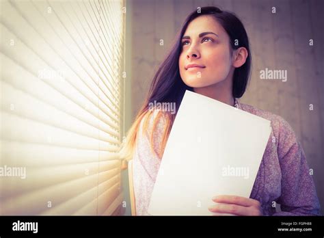 Pretty Brunette Reading Documents Beside Window Stock Photo Alamy