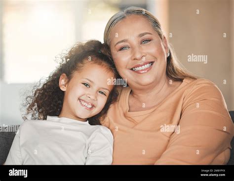 She Reminds Me Of My Youth A Mature Woman Bonding With Her Granddaughter At Home Stock Photo