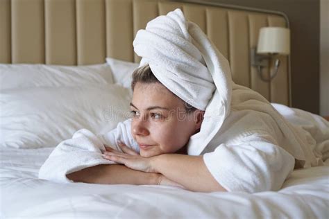 Beautiful Blonde Woman Lies On A Bed At Home Or In A Hotel Room After A Shower Stock Image