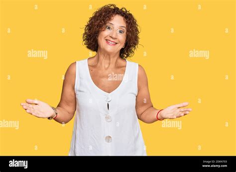 Beautiful Middle Age Mature Woman Wearing Casual White Shirt Clueless And Confused Expression