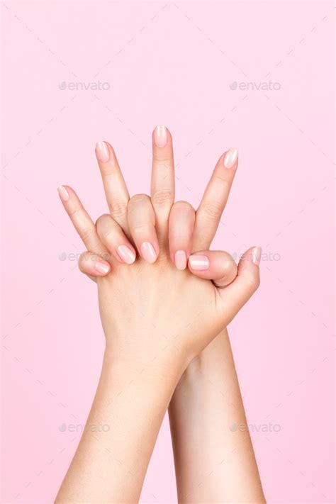 Female Hands With Nude Nails And Intertwined Fingers Stock Photo By Bykfa