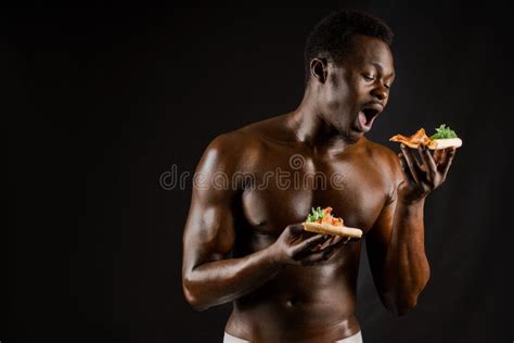 Black Handsome Naked Man Eats A Pizza Safety Food Delivery For People Who Stays At Home Stock
