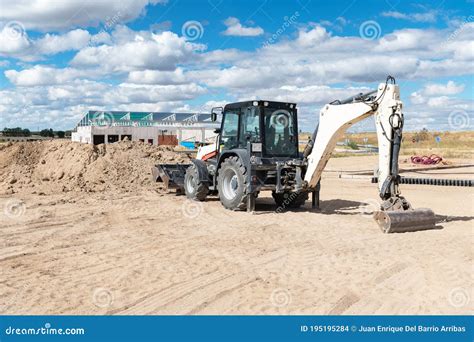 Backhoe Working By Digging Soil At Construction Site And Loading To The