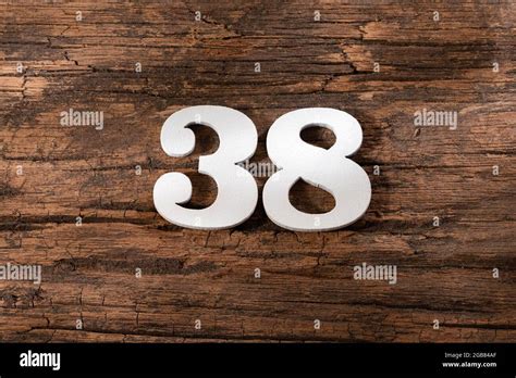 Number Thirty Eight 38 White Piece On Rustic Wood Background Stock