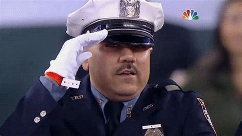 A Man In Uniform Saluting To Someone On The Television Show S News Program