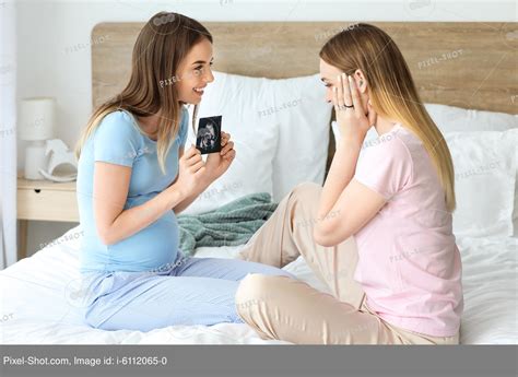 Pregnant Lesbian Couple With Sonogram Image In Bedroom Stock Photography Agency Pixel Shot