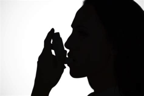 Premium Photo Asthmatic Brunette Using Her Inhaler Against White