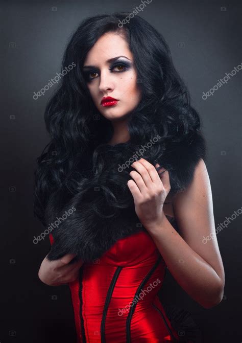 Sexy Brunette In Red Corset Fur And Long Hair In Studio Stock Photo By FlexDreams 10339537