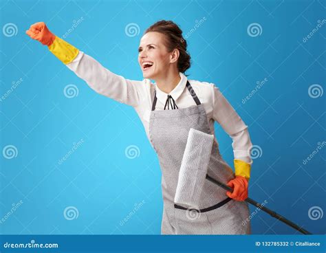 Superhero Style Young Cleaning Lady In Apron On Blue With Mop Stock