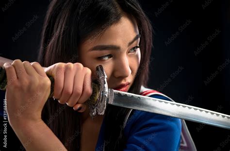 Portrait Of Pretty Brunette Lady With Red Lips Looking Like Warrior Asian Lady Posing Sword For