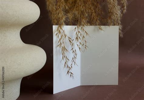 Blank Paper Mockup Template And Modern Beige Vasen With Dry Grass On