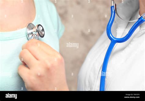 Female doctor listening patient's heart palpitations Stock Photo - Alamy