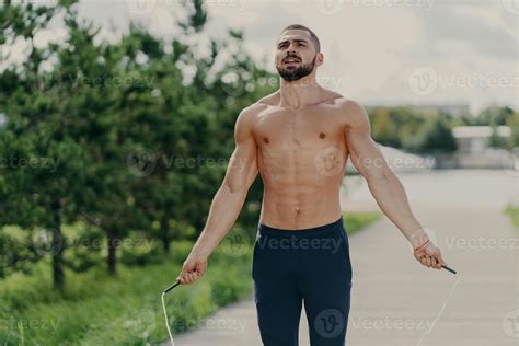 Athletic Motivated Man With Naked Torso Concentrated On Intense Fitness