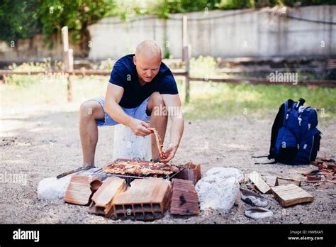 Man Cooking Bbq In Forest Green Park Stock Photo Alamy
