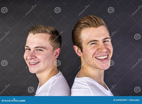 Two Teenage Boys Standing Back To Back And Have Fun Stock Photo Image