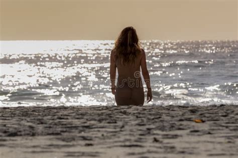 Lovely Brunette Bikini Model Relaxing On The Shoreline At Sunset Stock Photo Image Of Healthy