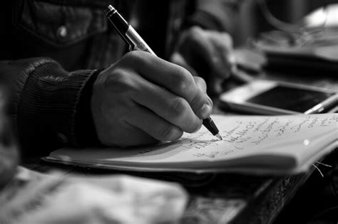 Person Writing On A Notebook Premium Ai Generated Image