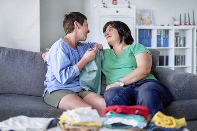Happy Lesbian Couple Folding Laundry Stock Image F Science Photo Library