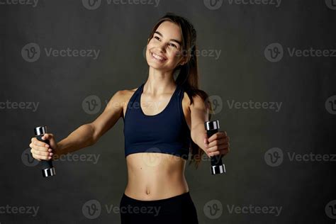 Sports Brunette With Dumbbells In Hands Workout Dark Background Fitness Stock Photo At