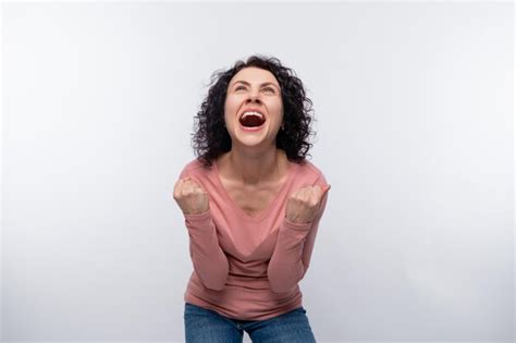 Premium Photo Happy Joyful Curly Brunette Woman Clenched Her Fists