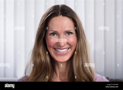 Portrait Of Smiling Mature Woman At Home Stock Photo Alamy