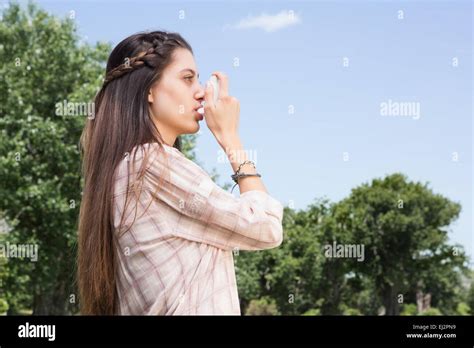 Pretty Brunette Using Her Inhaler Stock Photo Alamy