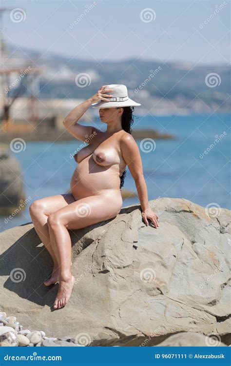 Naked Pregnant Woman Sunbathes On Wild Beach Stock Image Image Of