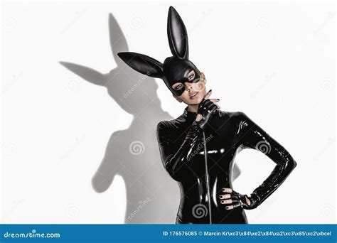 Blonde Beautiful Woman Posing In Latex Costume And Black Bunny Mask On White Background Stock