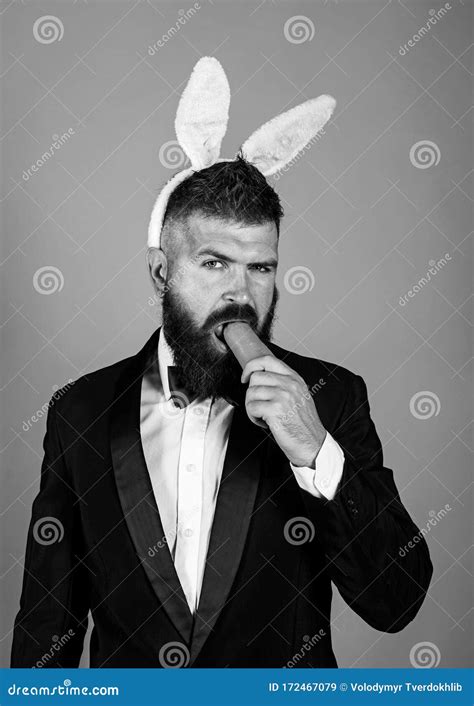 Easter Bunny Man Nibbles A Carrot Like A Hare Healthy Man On Holiday