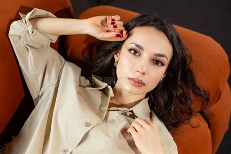 Sensual Brunette European Girl With Beautiful And Fair Skin Lying On The Couch Stock Image