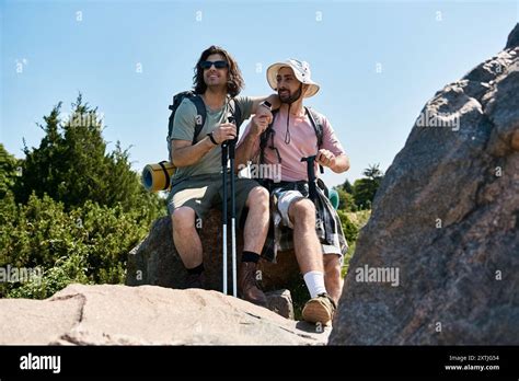 A Gay Couple Enjoys A Summer Hike Resting On A Rocky Outcrop In The Wilderness Stock Photo Alamy