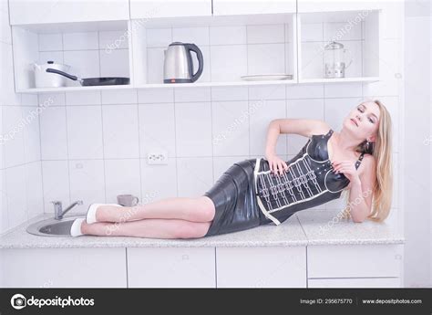 Beautiful Blonde Vamp Mistress In Black Fetish Corset On White Home Background Stock Photo By