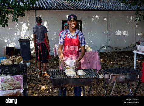 Men Making Roosterkoek On A Fire At The Blaauwklippen Wine Estate