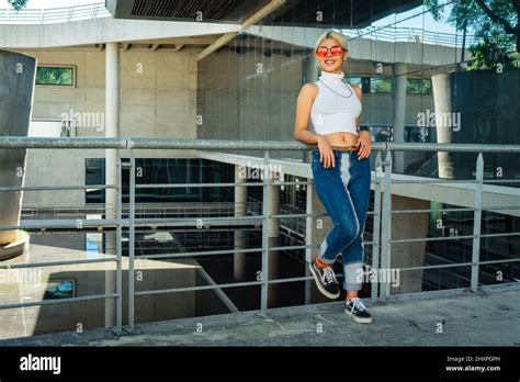 Latina Woman Waiting For Another Person Leaning On A Railing Stock Photo Alamy
