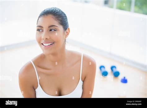 Happy Toned Brunette Sitting On Floor Stock Photo Alamy