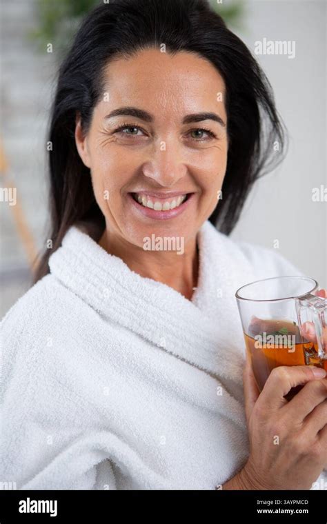Beautiful Brunette Drinking Herbal Tea After Spa Procedures Stock Photo