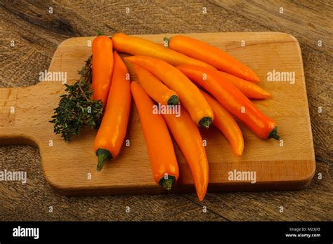 Hot Yellow Pepper Heap Over The Wooden Background Stock Photo Alamy