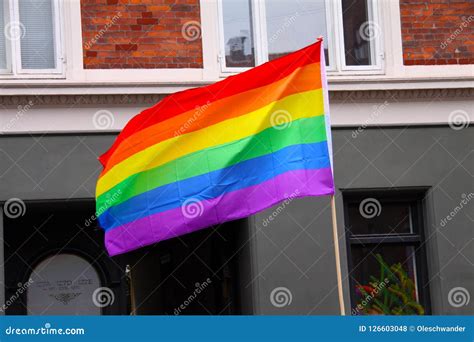 Rainbow Flag Waving In City At Pride Parade Lgbt Symbol For Gay Lesbian Bisexual Or