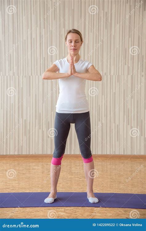Beautiful Blonde Girl Practices Yoga Asanas And Stretches On A Rug Stock Photo Image Of Female