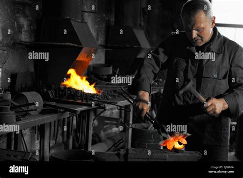 Front View Of Worker In Black Professional Uniform Working With Hot Metal Near Heating