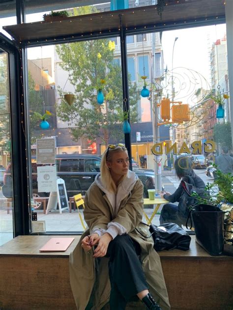 A Man Sitting On A Bench In Front Of A Window