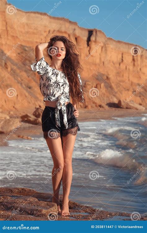 Brunette Summer Girl In Fashion Casual Outfit Enjpying On The Beach At Sunset Freedom