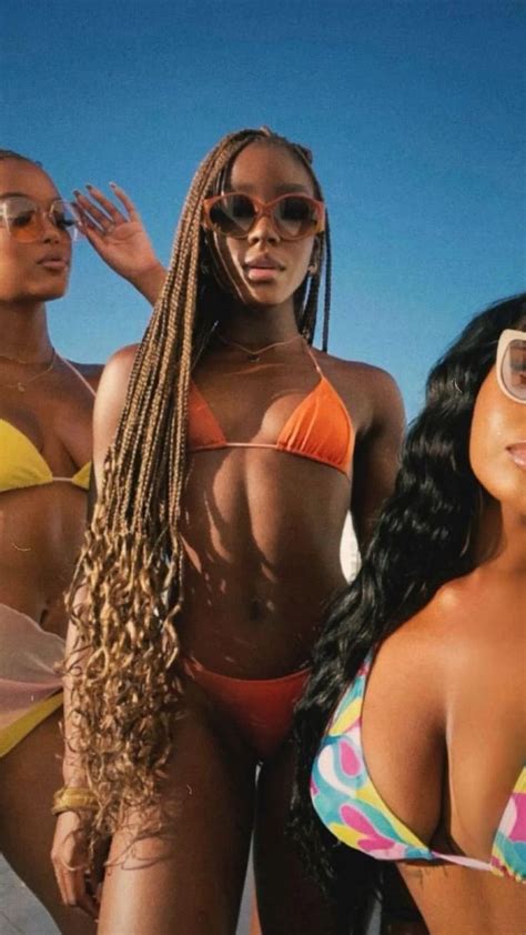 Three Women In Bikinis Standing Next To Each Other With Sunglasses On