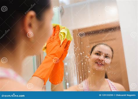 Cleanness In Every Move Pretty Brunette Cleans Mirror Stock Image Image Of Glove Chores