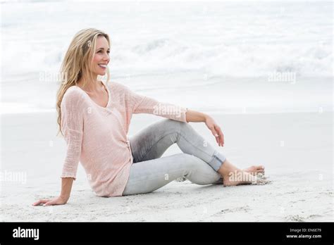 Smiling Pretty Blonde Relaxing On The Sand Stock Photo Alamy