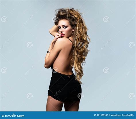 Beautiful Sensual Woman With Long Blonde Hair Standing Isolated Over Gray Isolated Stock Image