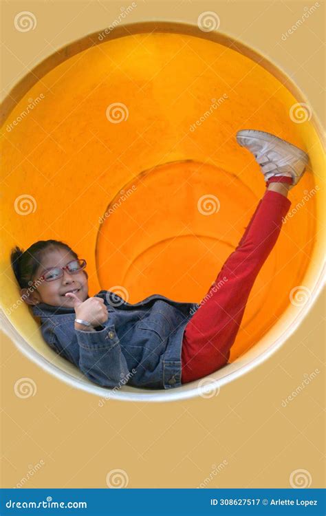 4 Year Old Latin Brunette Girl With Eye Glasses Plays In The Playground Park Doing Physical