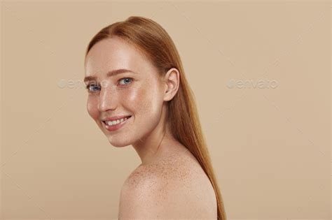 Redhead Caucasian Girl With Naked Shoulders Smiles Stock Photo By Vadymvdrobot