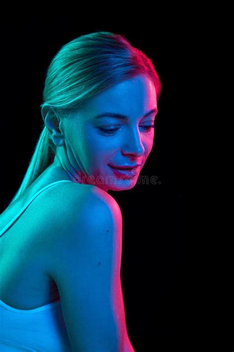 Tender Half Naked Woman Posing In Underwear Against Black Studio Background In Colorful Neon